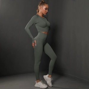 Detail of dark green seamless yoga set showing thumb holes and fine knit texture