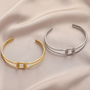 Elegant gold and silver titanium steel open bracelets with interweaving knot design on silk