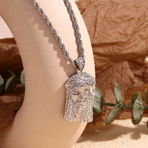 Macro shot of silver hip hop necklace featuring an iced-out Jesus head pendant on display