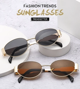 Nahaufnahme der Vintage-Oval-Sonnenbrille mit Goldmetallrahmen und breitem Bügeldesign