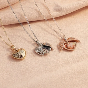 Three heart lockets in gold, silver, and rose gold with rose cutouts on pink fabric
