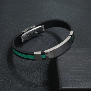 Close-up of stainless steel clasp with green Greek pattern on black silicone bracelet