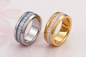 Close-up of gold and silver plated eternity rings with baguette-cut crystal stones