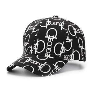Detail shot of black baseball cap featuring white geometric chain print and cotton texture