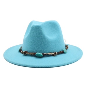 Detail view of the bright blue felt fedora featuring an ethnic turquoise beaded band