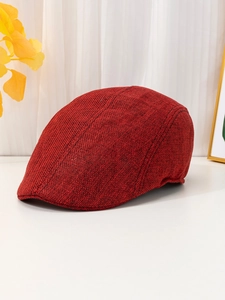 Detail of red linen breathable flat cap showing textured fabric and stitching quality