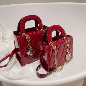 Glossy red patent leather lady bag with diamond quilting and heart charm details