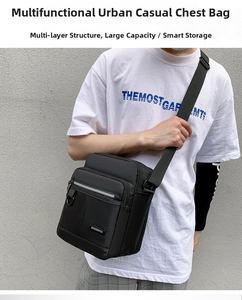 Detail of high-density black oxford cloth cross-body bag with reflective strip and metal logo