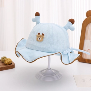 Detail view of baby sun hat with cute antlers, bear patch and adjustable drawstring