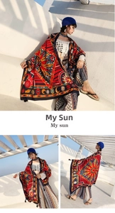 Detailed close-up of ethnic style sun and moon print shawl with decorative tassels