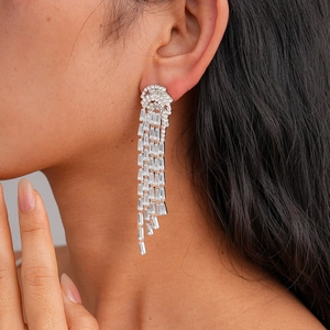 Silver jellyfish tassel earrings with zircon studs shown on a model for length and style