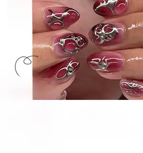 Detail view of 3D silver flame press-on nails with deep red smudge effect and liquid metal texture