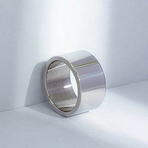Macro shot of 12mm wide polished titanium steel ring with brushed interior finish