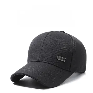 Close-up of black baseball cap with sport metal logo and textured cotton twill fabric