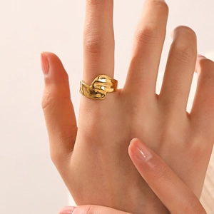 Irregular 18K gold plated stainless steel wave ring on model hand with minimalist style