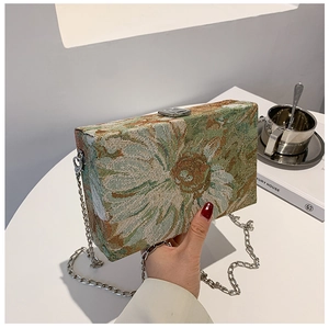 Detail view of vintage floral tapestry box bag with silver chain strap and metal clasp
