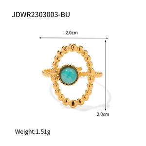 Macro detail of vintage gold-plated ring with turquoise stone and beaded oval frame