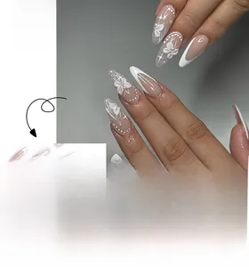 Macro detail of French stiletto press-on nails with 3D bows, pearls, and star patterns