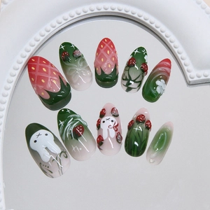 Glossy strawberry and rabbit press-on nails with floral 3D art on a mirror background