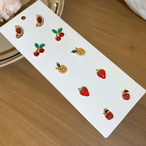 Detail of 6-pair fruit stud earrings set featuring crystal-set cherry and lemon designs
