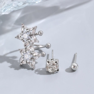 Macro shot of silver star ear cuff and cubic zirconia stud earrings three-piece set