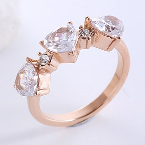Rose gold adjustable heart ring with three pear-cut white stones and pave accents