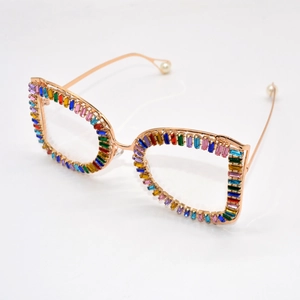 Detail of metal frame sunglasses with colorful rhinestones and pearl temple tips