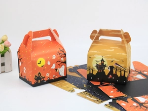Flat lay of unassembled Halloween pastry boxes with spooky ghost and castle patterns