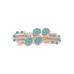 Detail of rose gold spring hair clip with intricate blue and white rhinestone flowers
