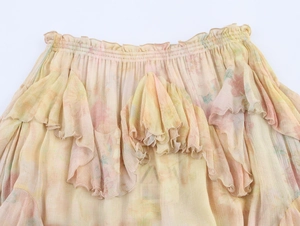 Detail of layered ruffle hem on floral chiffon skirt with delicate pleated texture