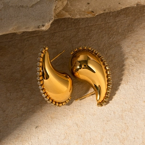 Macro shot of 18K gold plated teardrop earrings with pavé zircon on natural stone