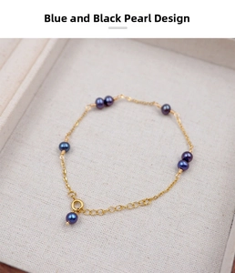 Detail view of gold-plated bracelet featuring blue-black pearls and refined wire-wrapping