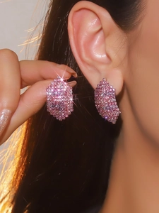 Close-up of pink pavé crystal geometric earrings on model for a luxurious look