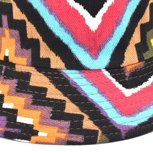 Close-up of the intricate geometric woven texture and mixed colors on a reversible bucket hat