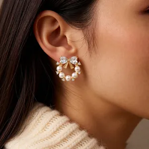 French luxury bow pearl earrings with zircon wreath design worn on an elegant model