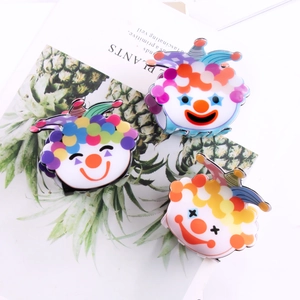 Three colorful cute clown hair claws in vibrant red, yellow, and blue PVC acetate