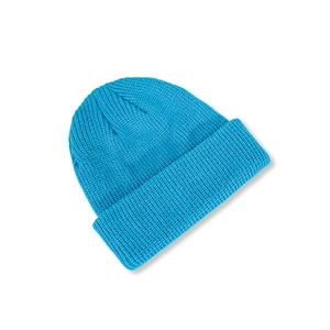 Detail of bright blue knitted beanie showing thick ribbed texture and classic folded cuff