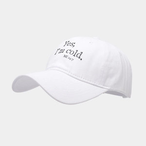 Detail of white washed cotton baseball cap featuring Yes I'm cold letter print design