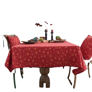 Red Christmas tablecloth with gold snowflake patterns and matching pillow covers