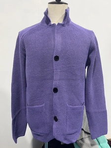 Close-up of purple waffle knit texture and black buttons on men's stand collar cardigan