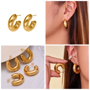 Detailed views of chunky gold C-shaped hollow hoop earrings with polished mirror finish