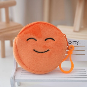 Detailed view of orange plush coin purse with smiley embroidery and plastic hook