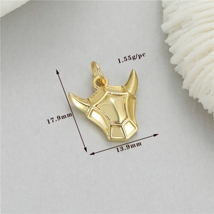 Detailed view of a golden bull head charm pendant showing 17.9x13.9mm size and 1.55g weight