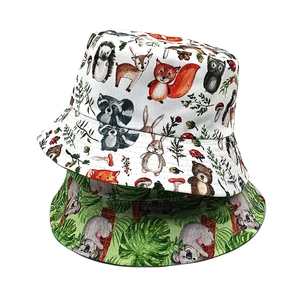 Detailed close-up showing reversible squirrel and tropical koala patterns on cotton bucket hats