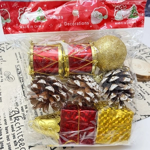 Close-up of Christmas tree ornaments set including pine cones and bells in plastic bag