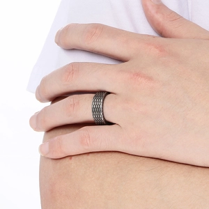 Close-up of a wide vintage silver stainless steel ring with a detailed dragon scale texture