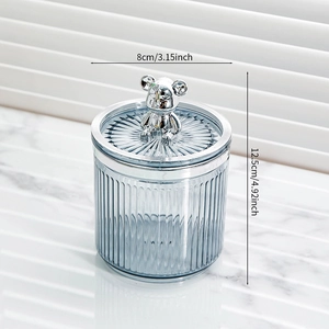 Vertical striped food storage jar with silver bear lid handle measuring 8cm by 12.5cm