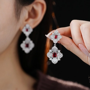 Vintage silver earrings with emerald cut ruby gemstones and sparkling halo accents