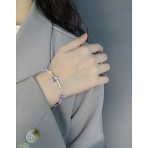 Elegant S925 silver bracelet with purple crystal beads and pearls on woman's wrist