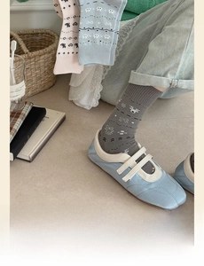 Close-up of Fair Isle knit socks with reindeer and snowflake patterns in pastel colors
